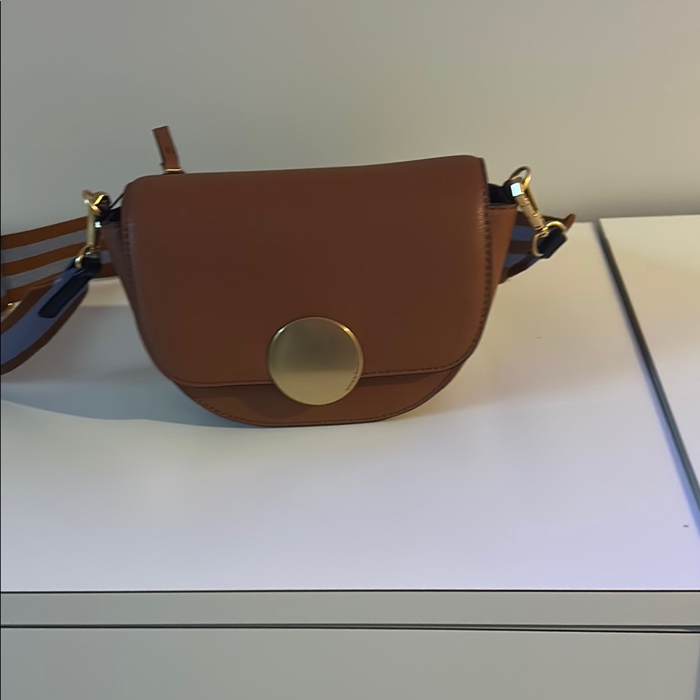 Cognac small bag, can be crossbody . Outside
 zip pocket.  A second strap